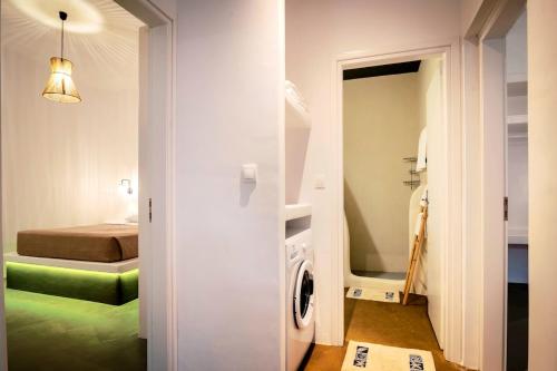 a bathroom with a washer and dryer in a room at Nora's ixia summer house in Ialyssos