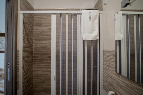 a shower with a sliding glass door in a bathroom at Coco'S Rooms in Bari Palese