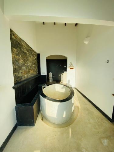 a large bathroom with a tub in the middle of a room at Southern grace unawatuna in Unawatuna