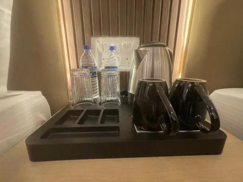 a tray with bottles of water and glasses on a table at Royal Casa Baga in Baga