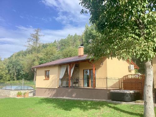 a small house in a yard with a tree at Apartmány Ořechovka Wellness in Turnov