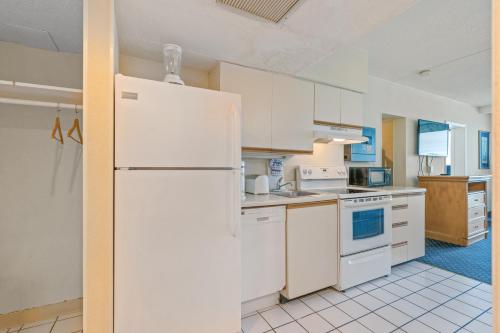 a kitchen with white appliances and a white refrigerator at Yachtsman Oceanfront Resort in Myrtle Beach