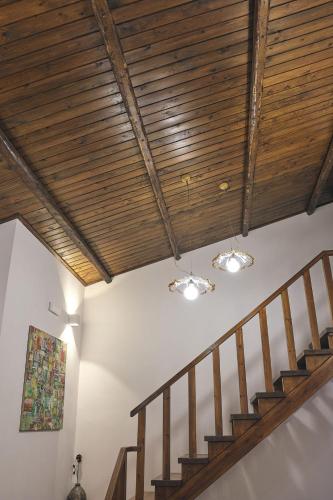 a staircase with a wooden ceiling with lights at casalerosaroom in Vinchiaturo