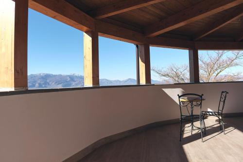 a chair sits on a balcony with a view of the mountains at casalerosaroom in Vinchiaturo
