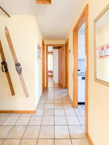 a hallway with skis hanging on the wall at Center of Nendaz ! Apartment 2 rooms with balcony in Nendaz