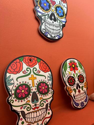 two day of the dead skulls plates on a wall at Kabatukila Pousada in Natal