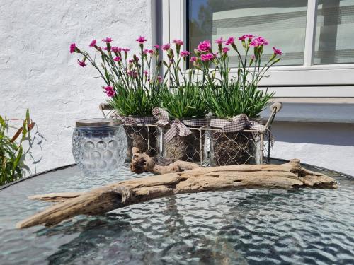 a table with flowers and a glass vase on it at Postgaarden Frøslev in Padborg