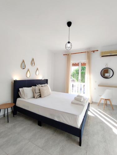 a bedroom with a large bed in a room at Panagiotis Studios in Laganas