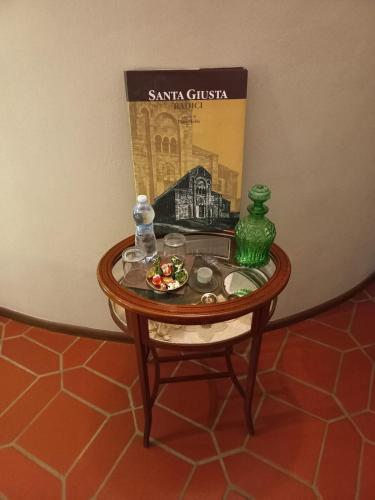 a table with a book and a plate of food on it at B&B Filomena in Santa Giusta