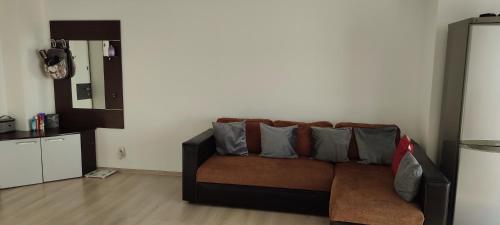 a living room with a couch with pillows on it at Cristina's Place!! in Sibiu