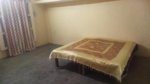 a room with a bed with a carpet on it at Utkarsh HomeStay near Kumbh Mela Prayagraj in Prayagraj