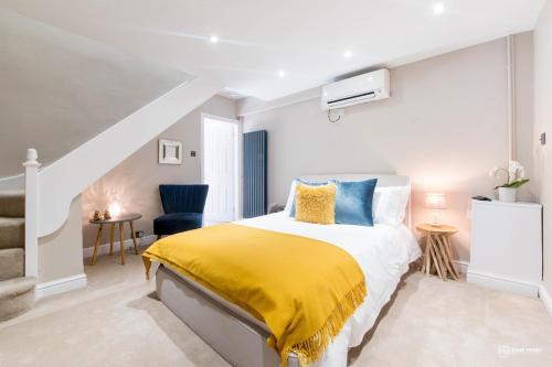 a bedroom with a bed with a yellow blanket at The Hideaway in Warwick