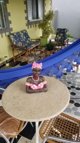 a plastic doll sitting on top of a table at A pequena casa de pedra in Morungaba