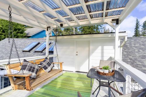 a porch with a swing and a house at Lakefront cottage with AC in Federal Way