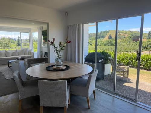 a living room with a table and chairs at Wineries and cycle tracks on your doorstep in Havelock North
