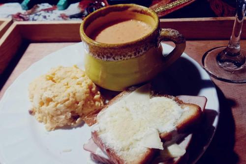 a plate with a sandwich and a cup of coffee at Boresta House -Santa Elena con vista al Bosque y terraza privada in Medellín
