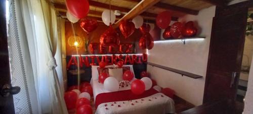 a room with red and white balloons on the wall at Boresta House -Santa Elena con vista al Bosque y terraza privada in Medellín