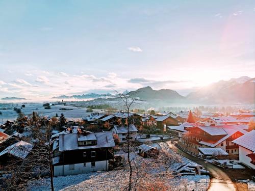 a small town with snow on the roofs of houses at Sunrise Pfronten - Budget in Pfronten