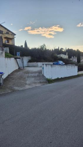 an empty street with a white fence and a building at Appartamenti di Claudia, Locazione turistica in Spoleto