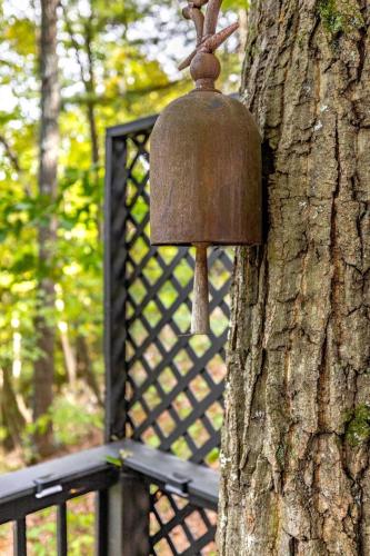 a bird feeder is attached to a tree at The Nest in Berkeley Springs