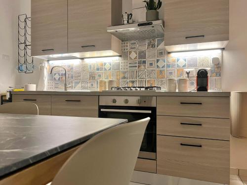 a kitchen with a counter and chairs in it at Casa Spartea Cilento coast in Marina di Camerota