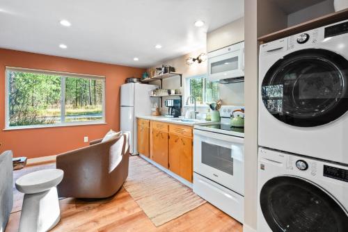 a kitchen with a washer and dryer at Laid Back Cabin 7 Mn To Glacier, Private Fire Pit in Coram