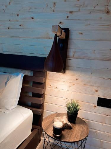 a room with a bed and a table with a lamp at Apusenity- Refugiu modern în inima naturii, aproape de Cluj in Cluj-Napoca