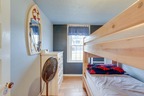 a small bedroom with a bunk bed and a mirror at Less Than half Mi to Beach Wildwood Getaway with Patio! in Wildwood