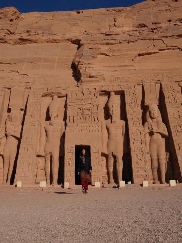 a man standing in front of anaraoharaoh at Karma Kono in Abu Simbel