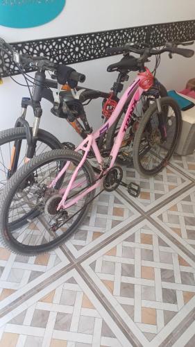 a pink bike is parked on a floor at Sunny sky in Quseir