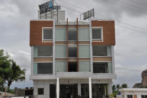 a building with a balcony on top of it at Alps Residency - A Bergamont Hotel, Krishnagiri in Krishnagiri