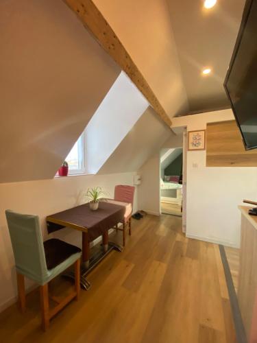 une salle à manger avec une table et des chaises en bois dans l'établissement Porte du Casino, à Forges-les-Eaux