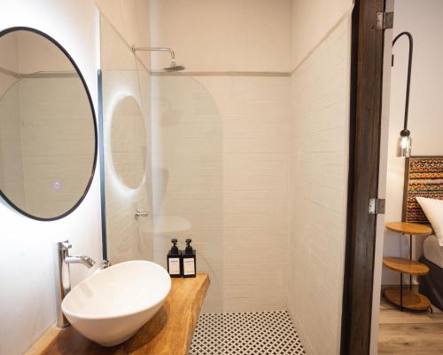 a bathroom with a sink and a mirror at Paradiso Hostel in La Laguna