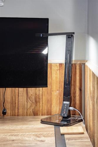 a phone sitting on a glass table next to a tv at Gnomerson’s Hideaway in Packwood