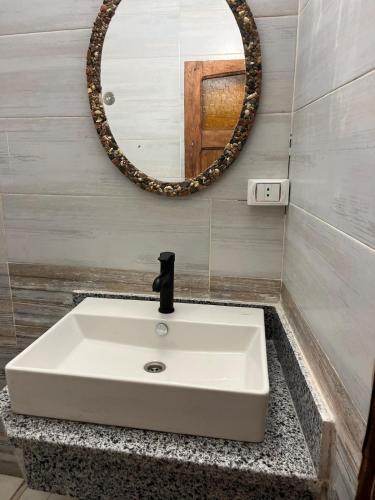 a white sink in a bathroom with a mirror at Ge boho house in Dahab