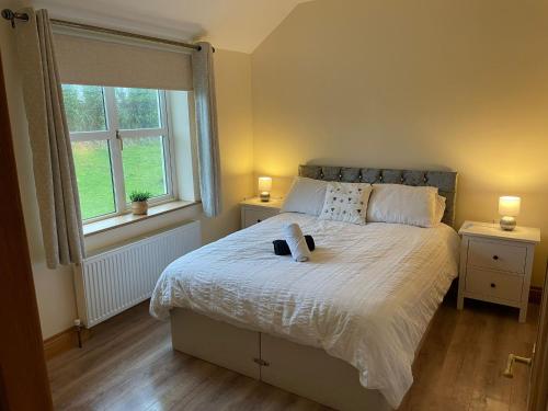 a bedroom with a bed with a book on it at Molly's Self Catering Accommodation in Cavan