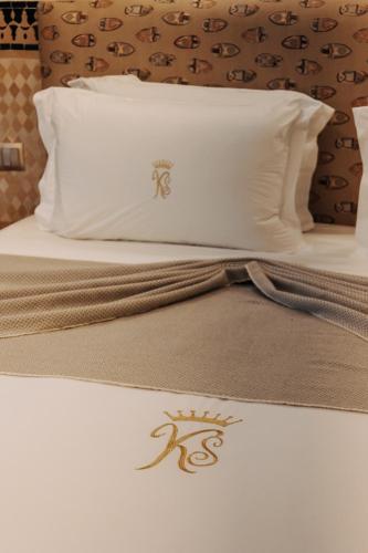 a bed with two pillows and a laptop on it at Riad Ksar Al Amal & Spa in Marrakech