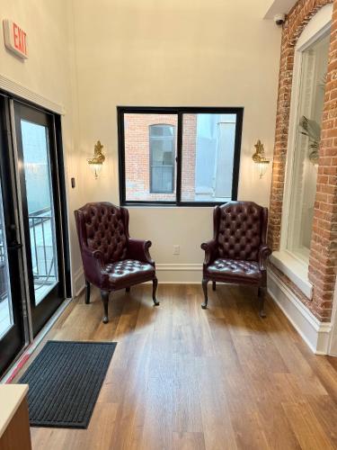 two chairs in a waiting room with windows at The Beau Hotel Downtown San Diego Gaslamp Quarter in San Diego