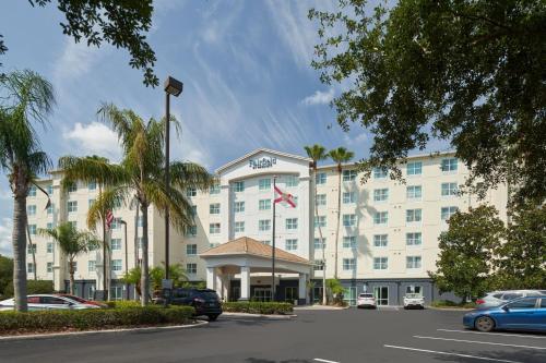 an exterior view of a hotel with cars parked in a parking lot at Fairfield Inn & Suites by Marriott Orlando International Drive/Convention Center in Orlando