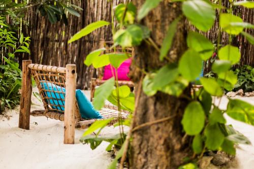 a woman sitting in a hammock in a tree at Zanzistar Lodge in Jambiani