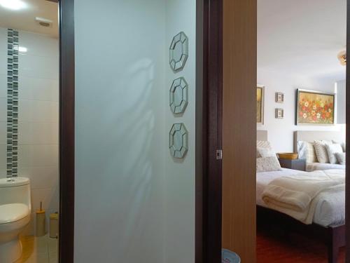 a bedroom with a bed and a bathroom at CENTRAL Apartment, 3Beds - Balcony - Parking - 6thFLOOR in Quito