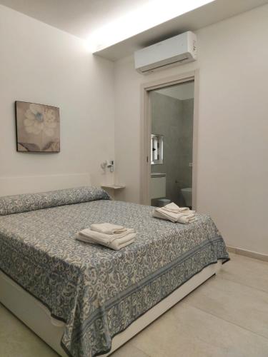Ένα ή περισσότερα κρεβάτια σε δωμάτιο στο Ninfa Bed and Breakfast