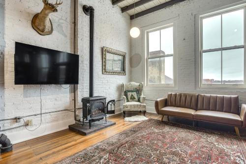 a living room with a couch and a fireplace at Less Than 1 Mi to Wittenberg Eclectic Loft with Parking! in Springfield