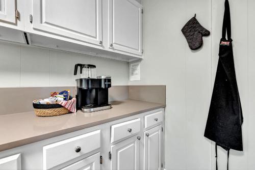 a kitchen with white cabinets and a coffee maker on a counter at University Place, family stay, practically on JBU campus in Siloam Springs