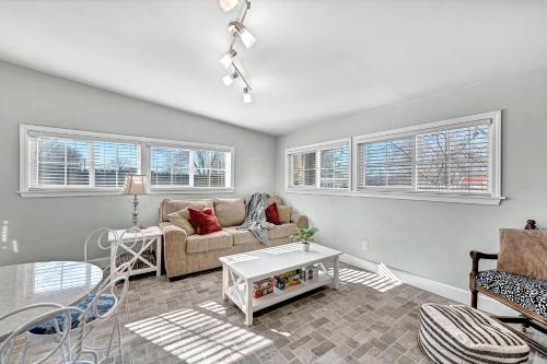 a living room with a couch and a table at University Place, family stay, practically on JBU campus in Siloam Springs