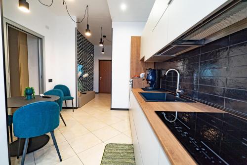 a kitchen with a counter and a table and chairs at Cerasè Apartment in center-Sorrento Coast in Vico Equense