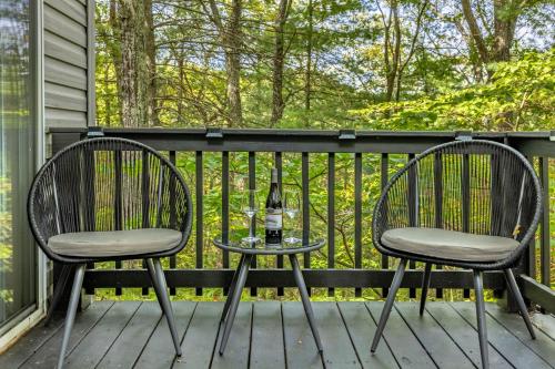 two chairs and a table with a bottle of wine on a porch at The Nest in Berkeley Springs