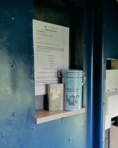 a shelf with two jars and a box on it at Mind The Gap in Preston