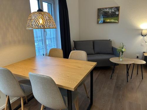 a living room with a table and chairs and a couch at Gasthof Sternen Detligen in Detligen