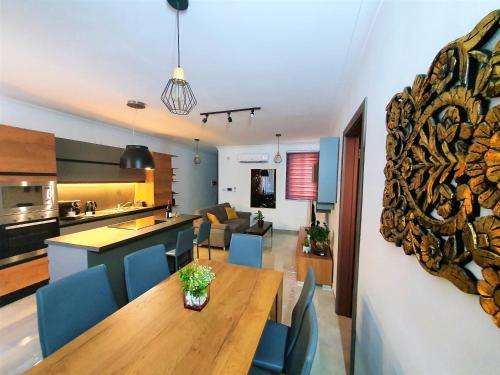 a kitchen and a living room with a table and chairs at Msiebah Court San Gwann Modern Apt near Sliema and St Julians in San Ġwann